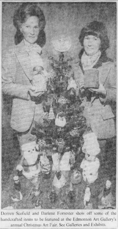 A black and white newspaper clipping of two volunteers at Christmas, in front of a miniature tree.
