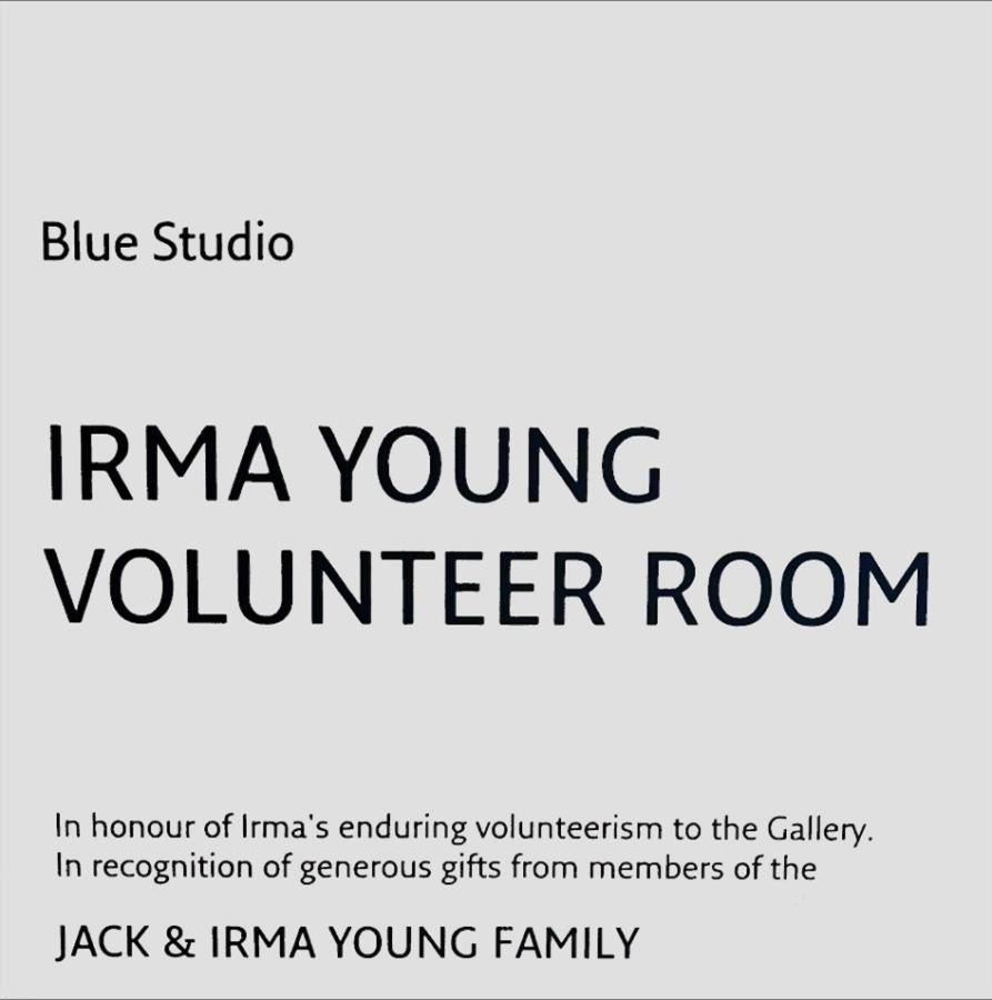 a photo of a placard that reads: Blue Studio - Irma Young Volunteer Room, followed by (in smaller letters): In honour of Irma's enduring volunteerism to the Gallery. In recognition of generous gifs from members of the Jack & Irma Young family.
