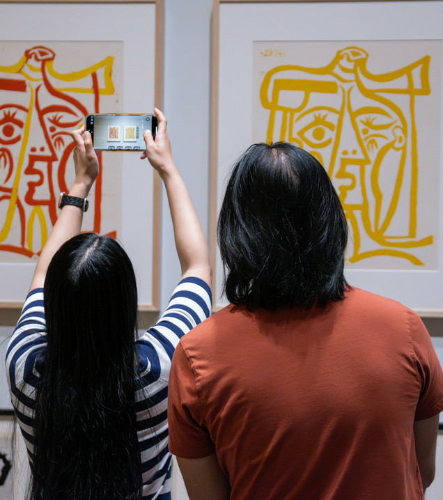 An individual explores a landscape painting.