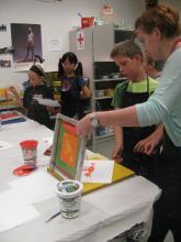 Children making prints with instructor