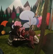 Circle of kids reading in the Wild Wood children's gallery